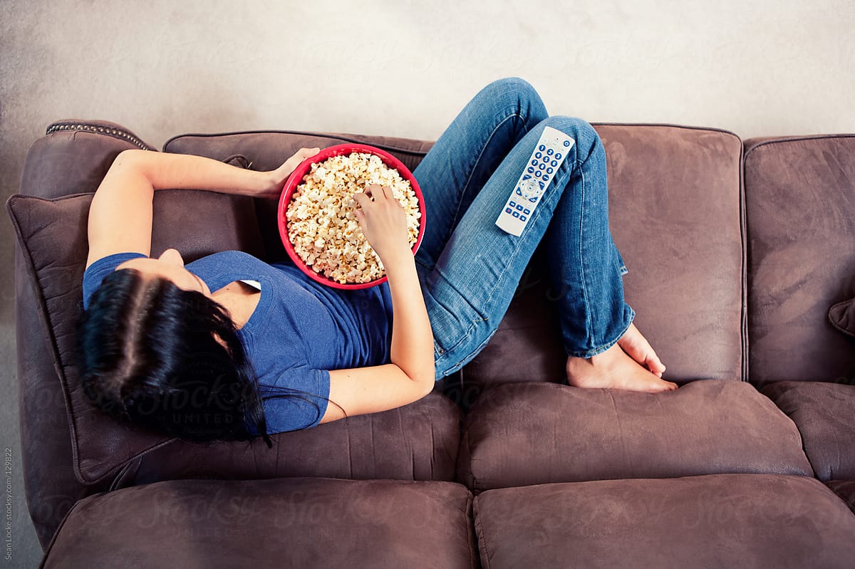 Television: Woman Relaxes on Couch Watching TV