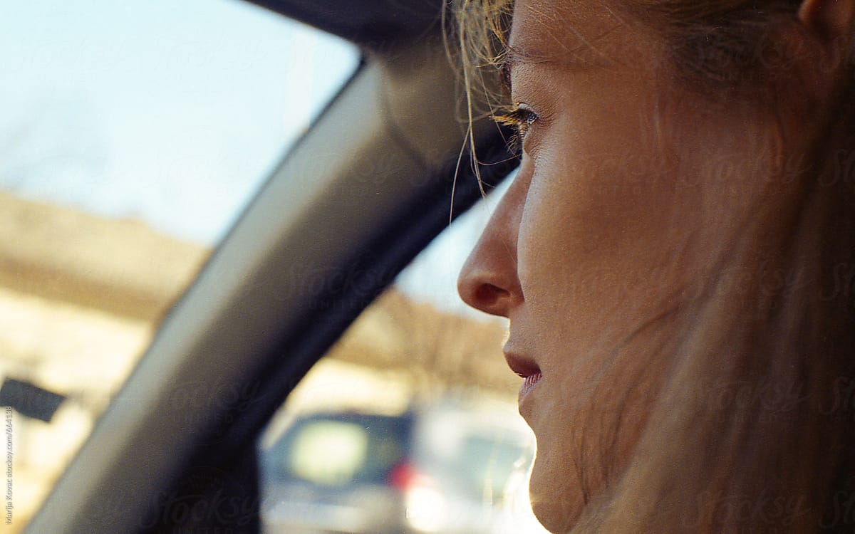 Young Woman Looking Through The Car Window by Stocksy Contributor Marija  Kovac - Stocksy