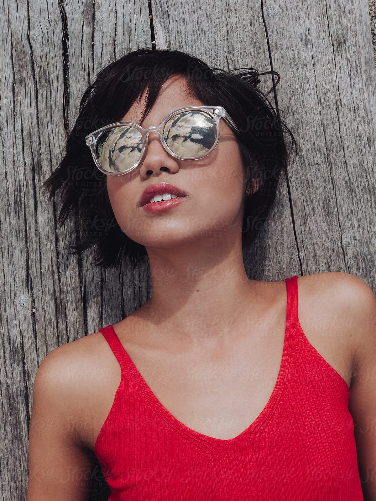 Girl With Sunglasses Looking At The Sky By Stocksy Contributor Paff