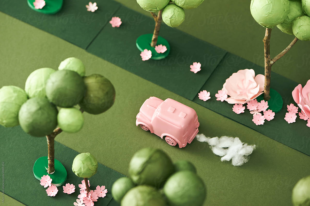 A pink car mini model running on street