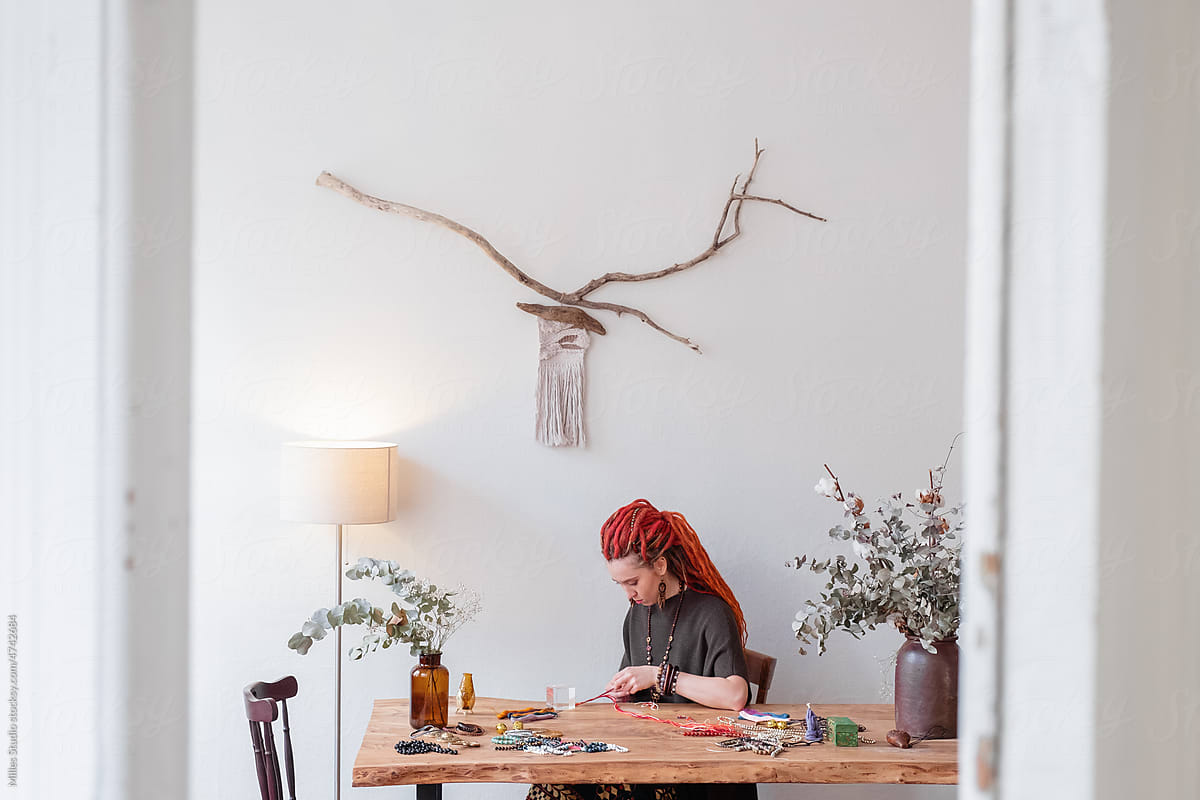 Female artisan working in light home studio