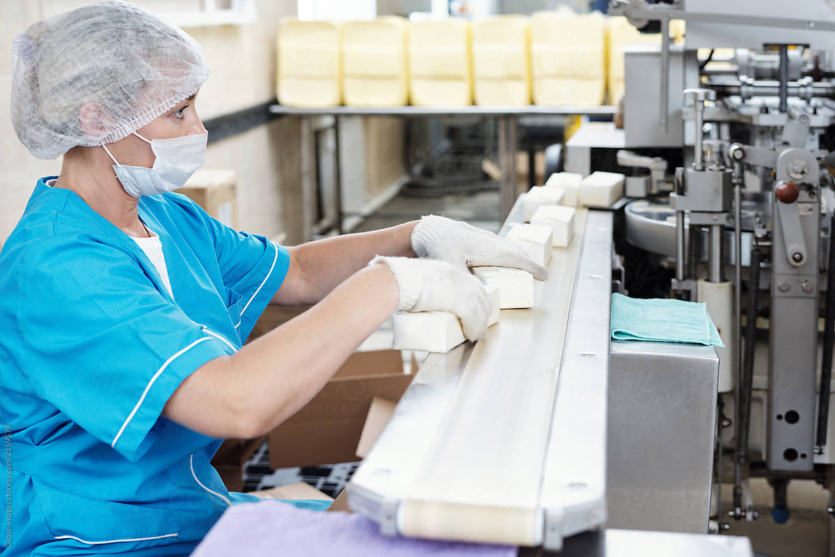 Woman Packaging Butter At Factory