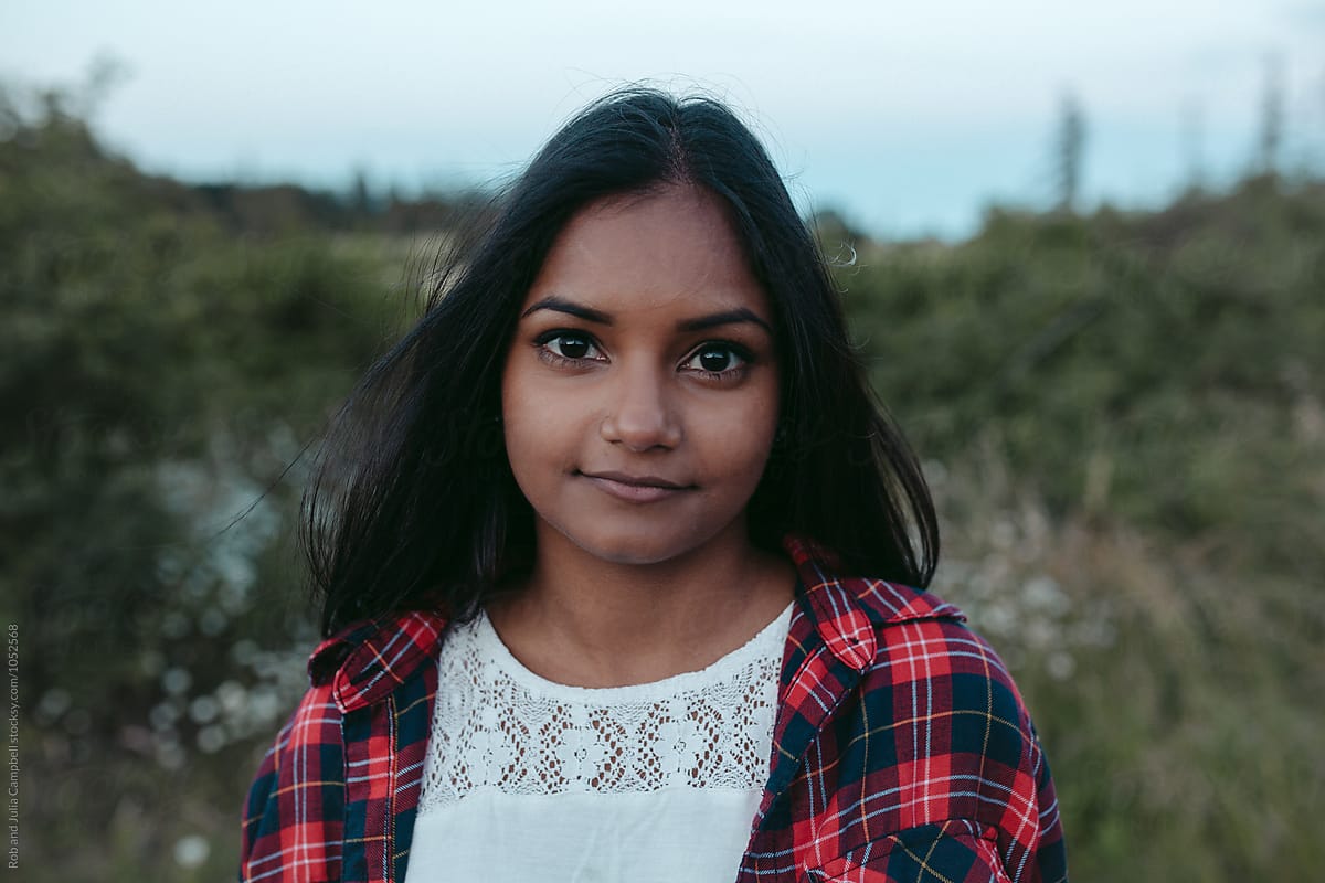 Portraits Of Young South Asian Girl Enjoying Being Outside By Stocksy
