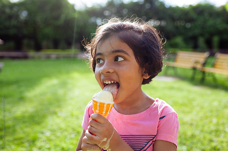 Little girl enjoying an ice cream outdoors