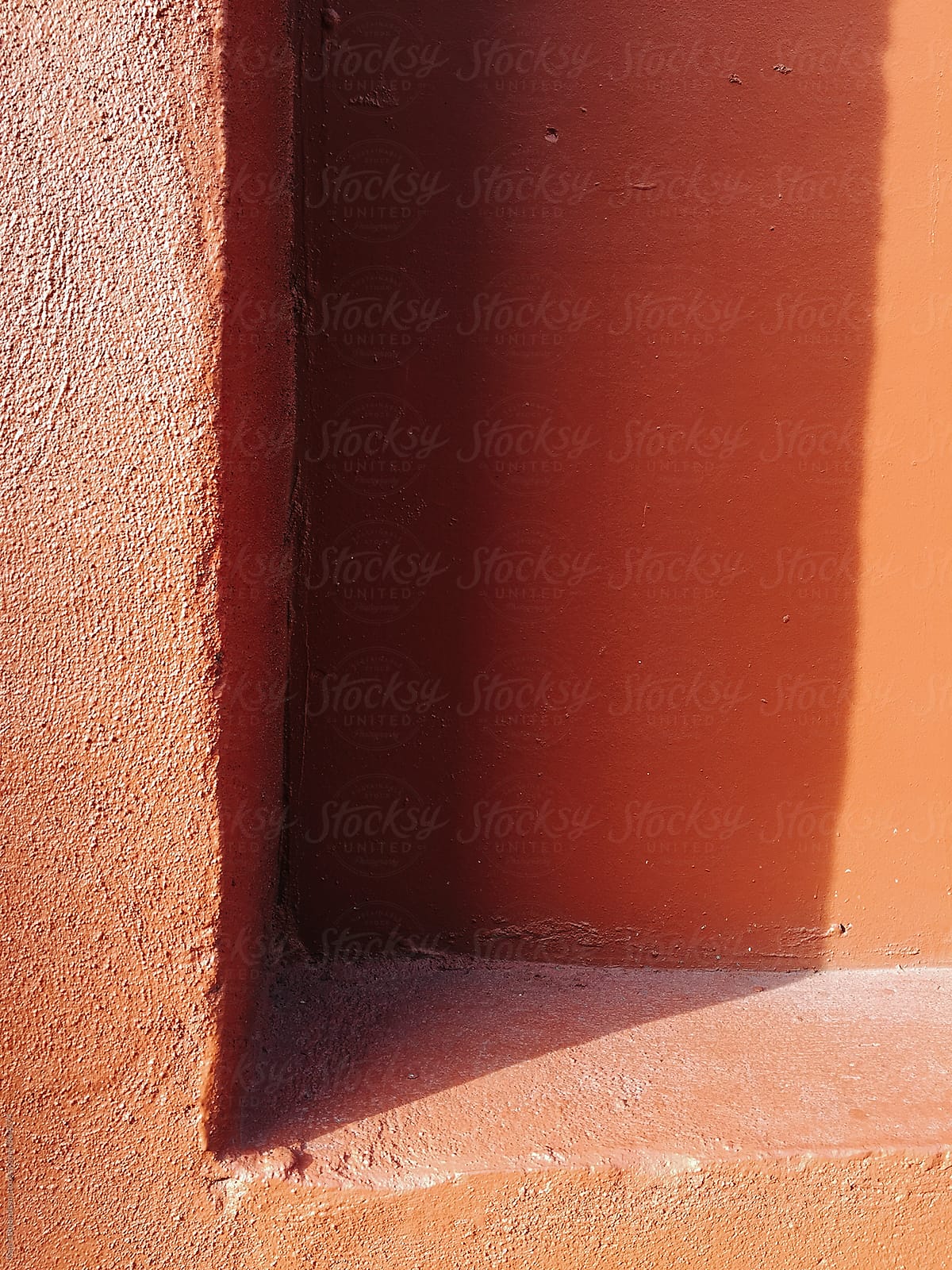 Corner of building doorway, casting shadow