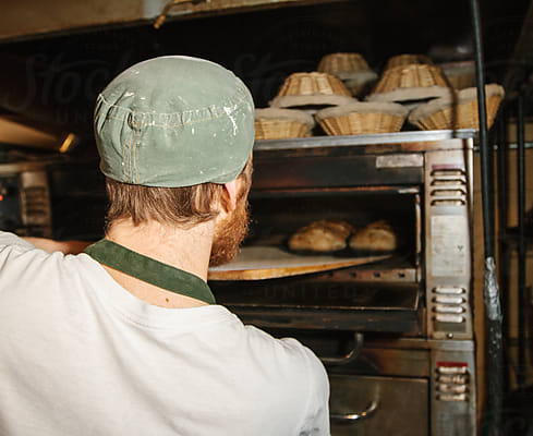 Baker Posing With His Freshly-baked Bread At A Small-scale, Artisan Bakery  by Stocksy Contributor Misha Dumov - Stocksy