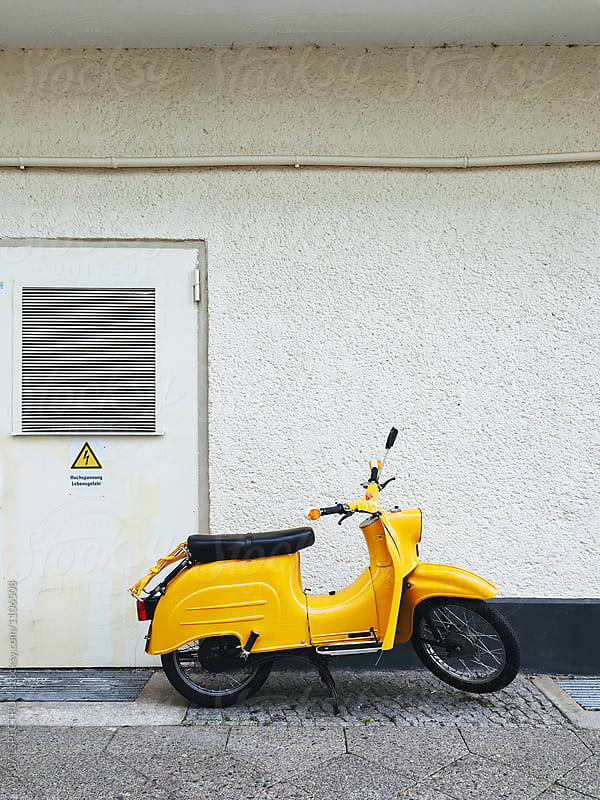 Yellow Retro GDR Motorbike in Front of White Wall