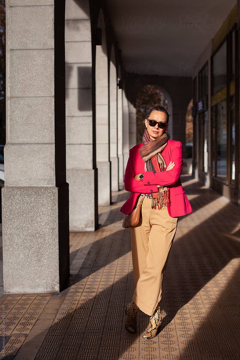 stylish mature business woman in pink jacket and sunglasses, portrait
