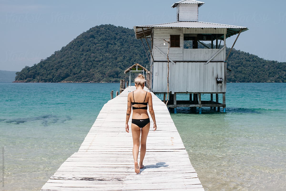 Young fashionable asian female model wears bikini swimsuit at beach