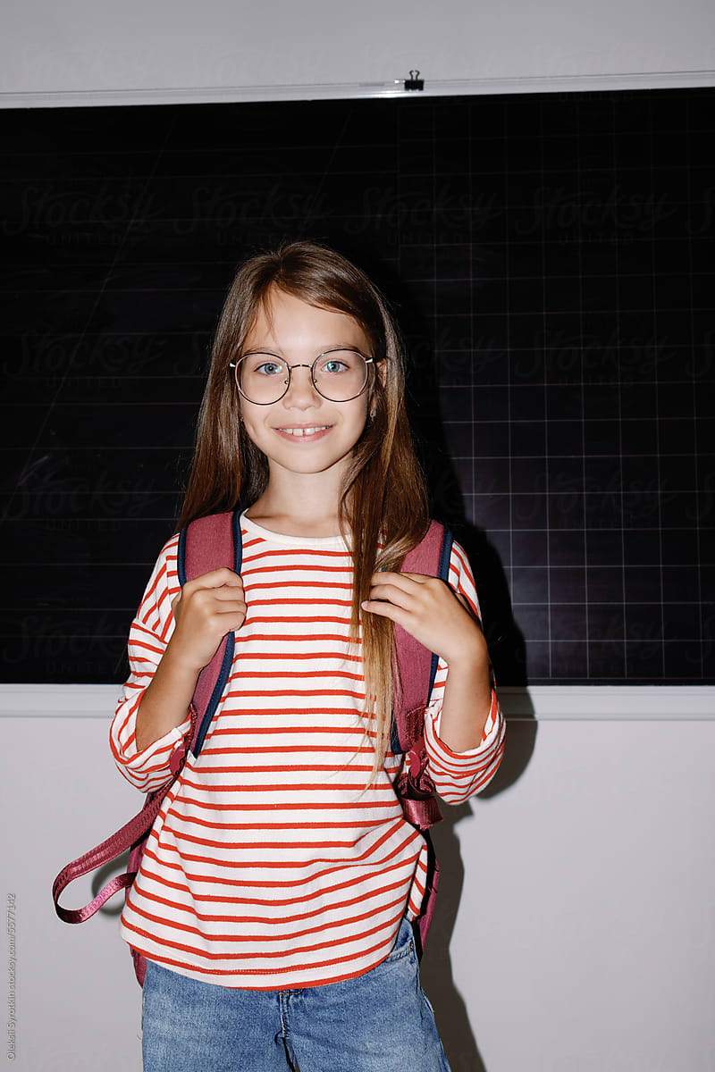Schoolgirl schoolbag chalkboard auditorium education smile excitement