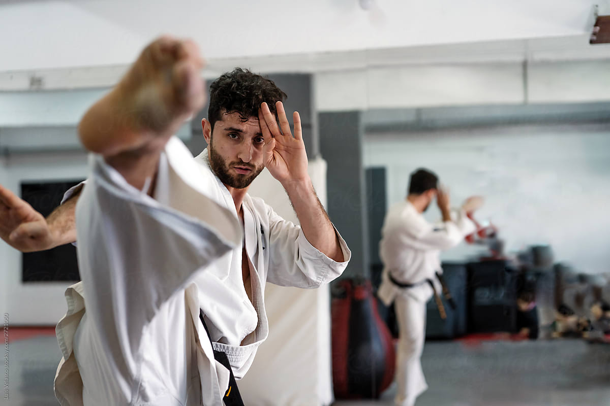 Man Doing Karate In The Studio In Front Of The Mirror.
