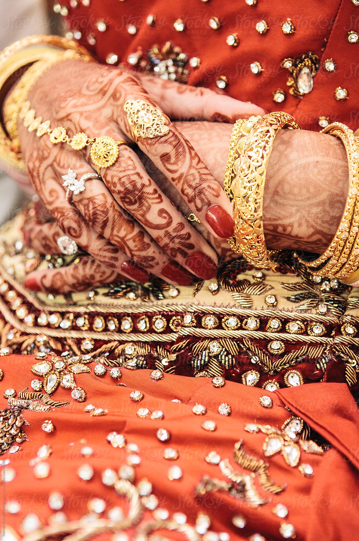 Indian woman\'s hands painted with henna.