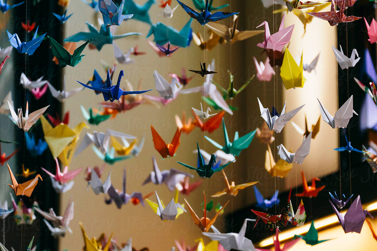 Colorful origami cranes suspended. Paper folding craft