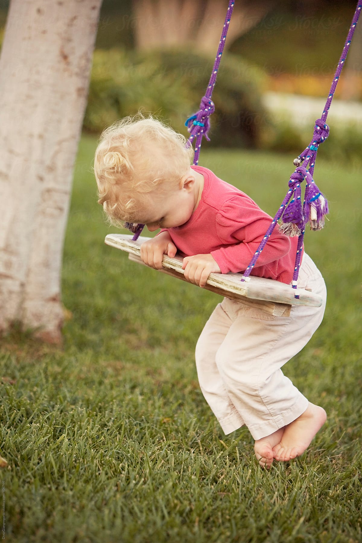 Toddler On Homemade Wooden Swing