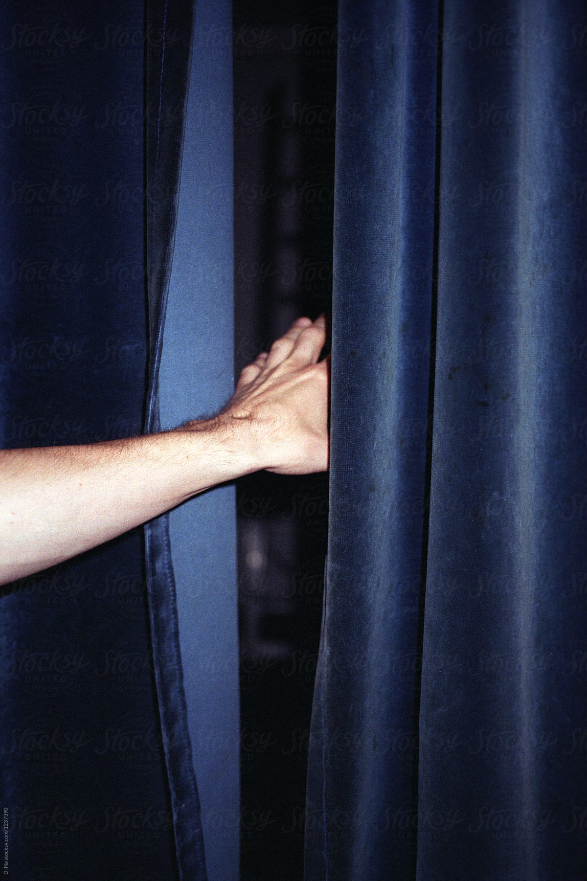 Hand and blue velvet blackout curtains