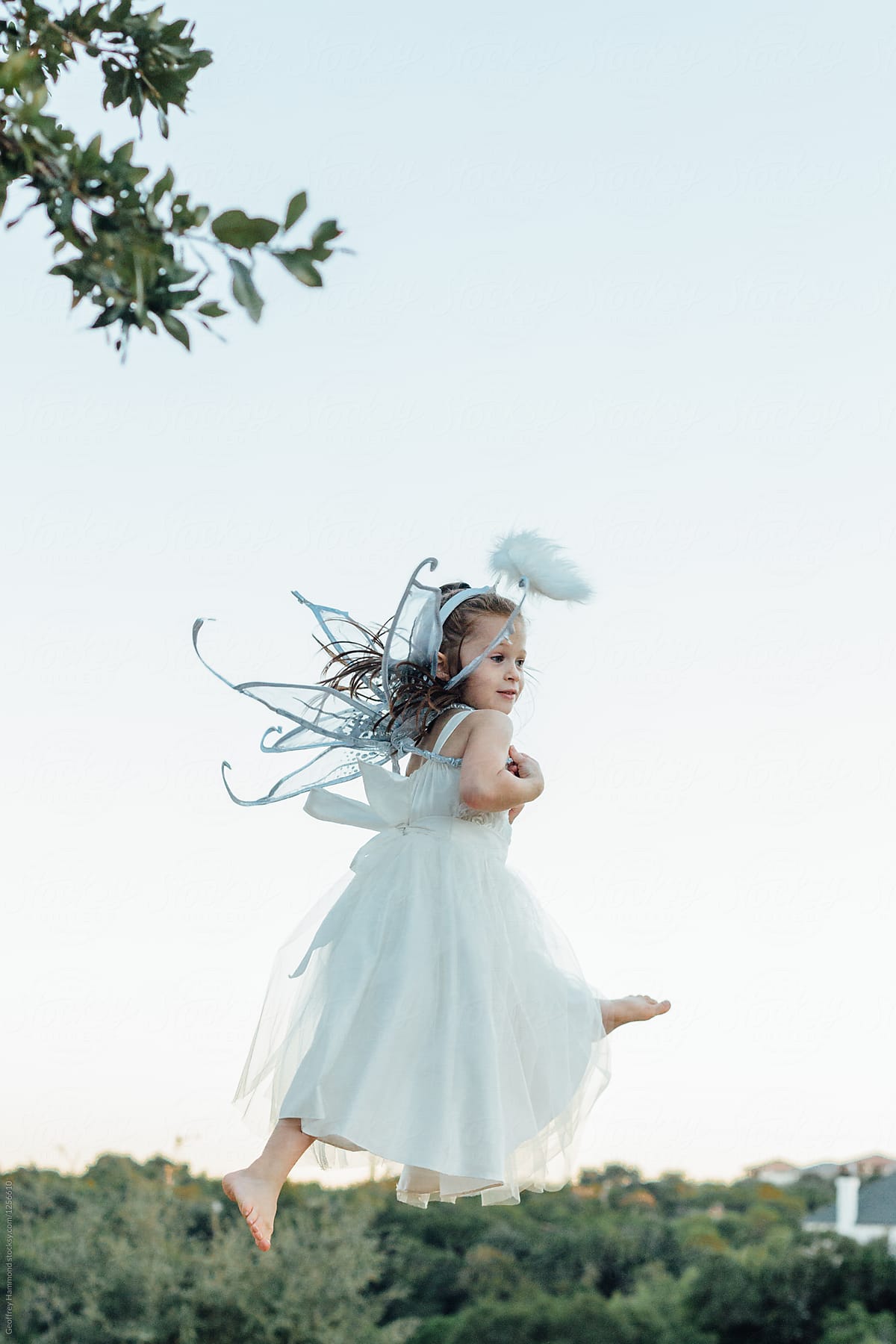 Girl Wearing Angel Costume in Mid-Air
