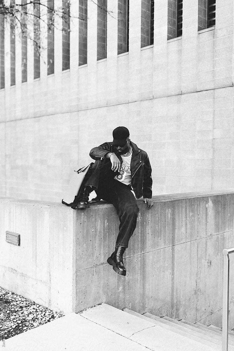 Urban Man Sitting On Concrete Ledge