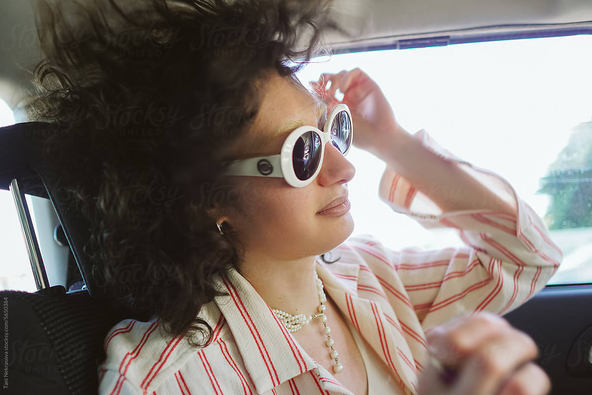 Portrait of a girl traveling in a car in a sunglasses