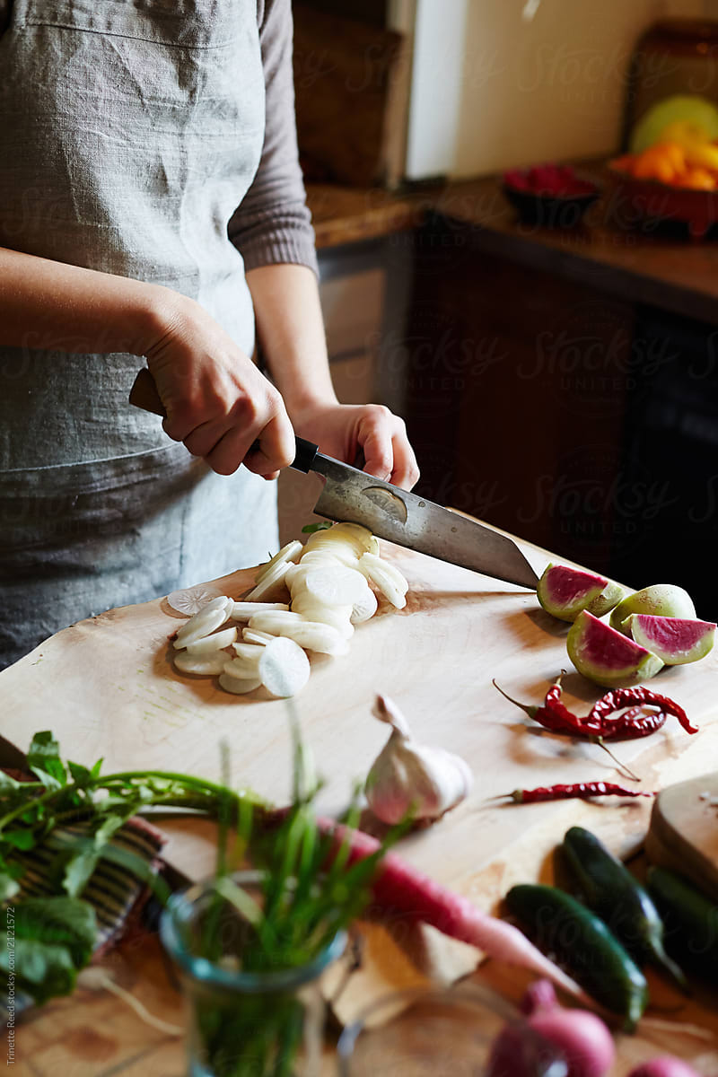 Woman chopping daikon while cooking