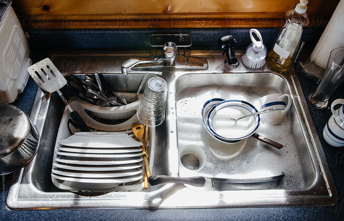 Sink filled with dishes and soapy water