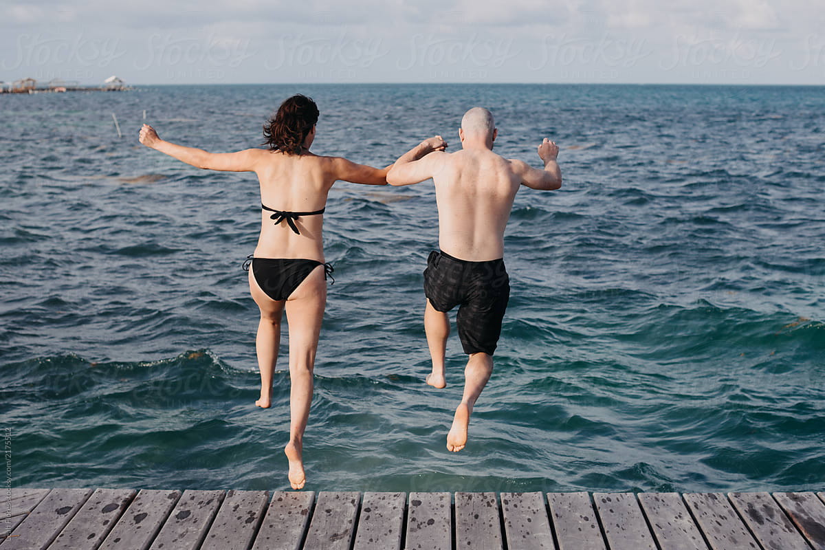Couple Jumping into the Ocean