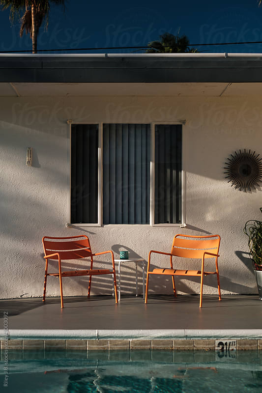 Orange lounge chairs next to a pool
