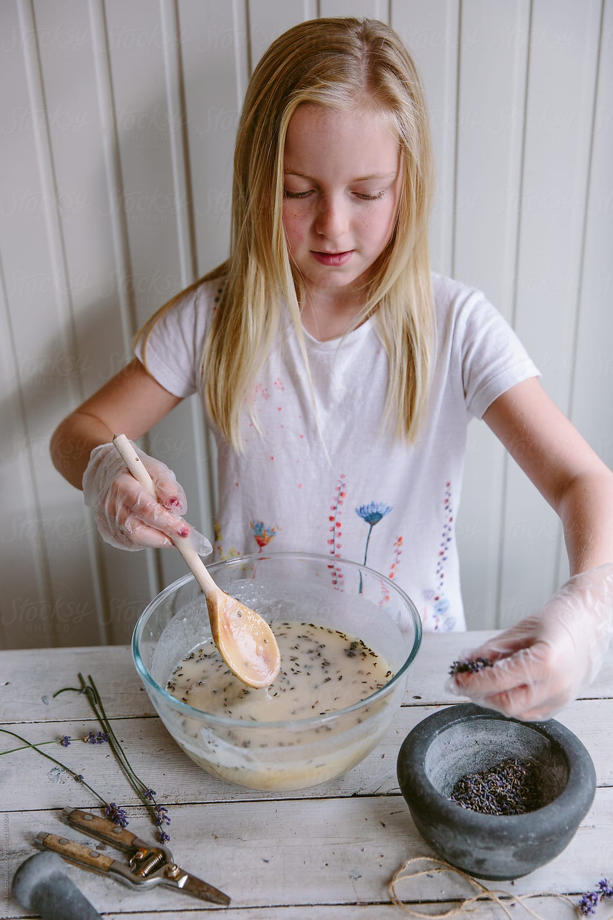 A female child making lavender soap