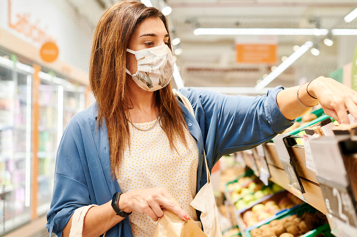 Woman in a face mask shopping for groceries