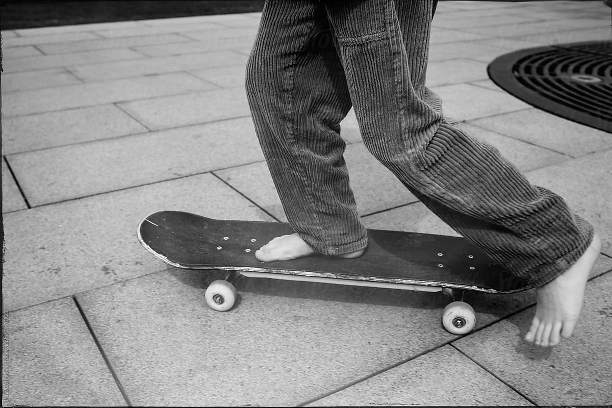 Barefoot anonymous riding skateboard