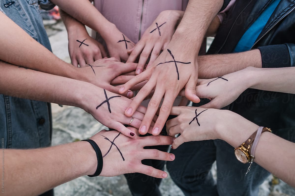 Anonymous group of teenage friends with streight edge sign on their hands