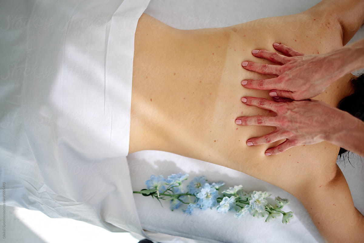 Masseur doing relaxing body massage for client