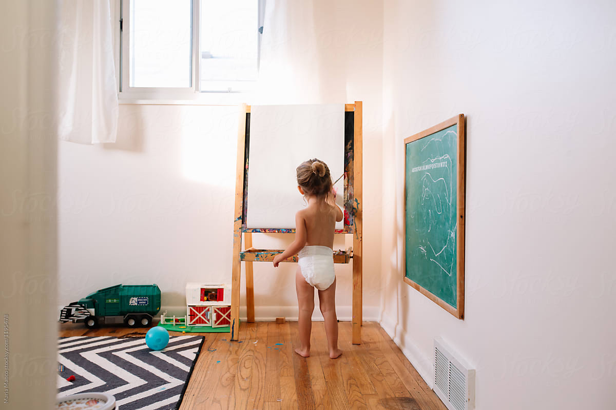 Little Girl Painting At Easle In Diaper by Stocksy Contributor Maria  Manco - Stocksy