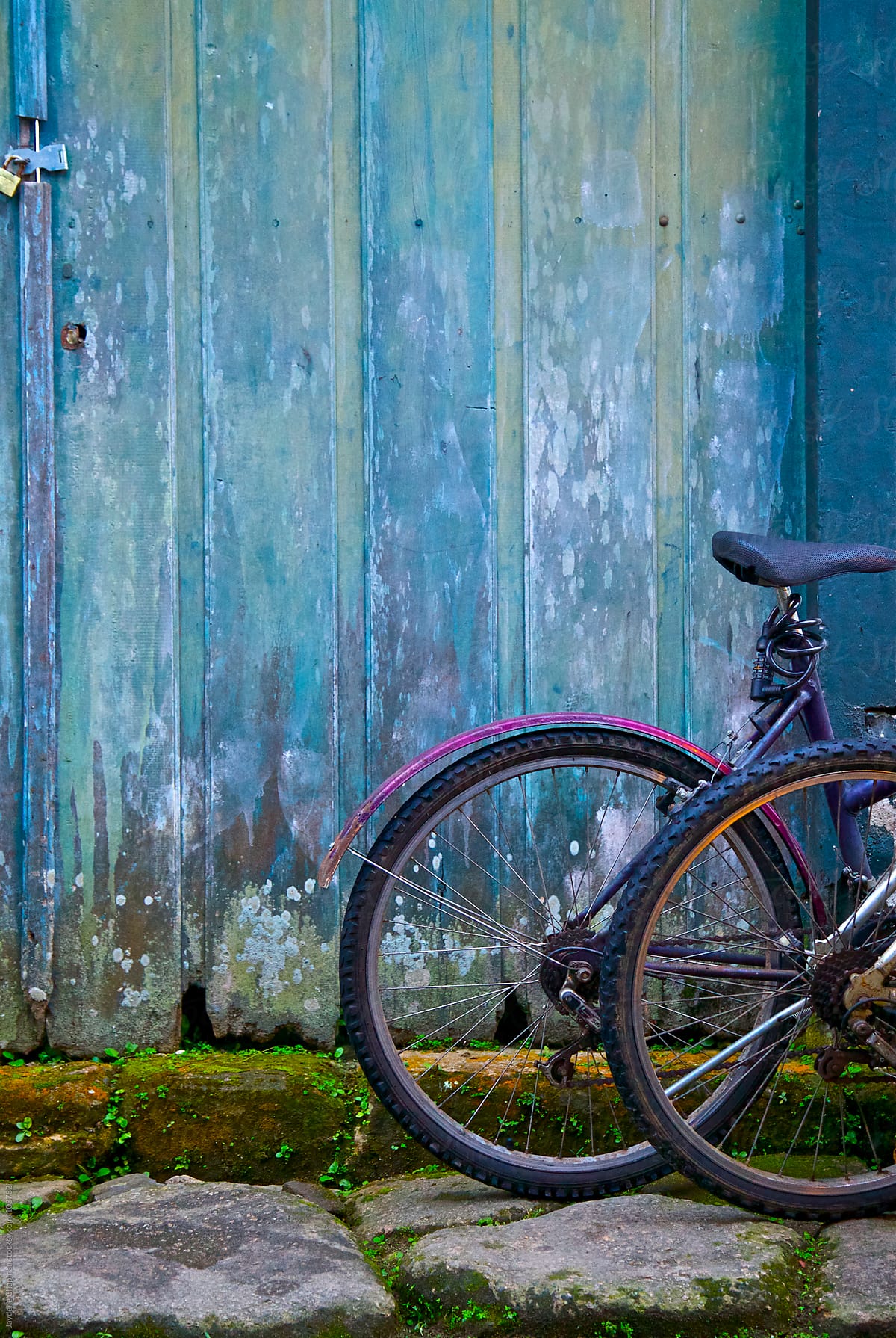 Bike outside an old blue painted wooden doored