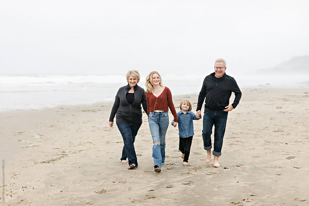 Grandparents Walking with Grandchildren on Beach