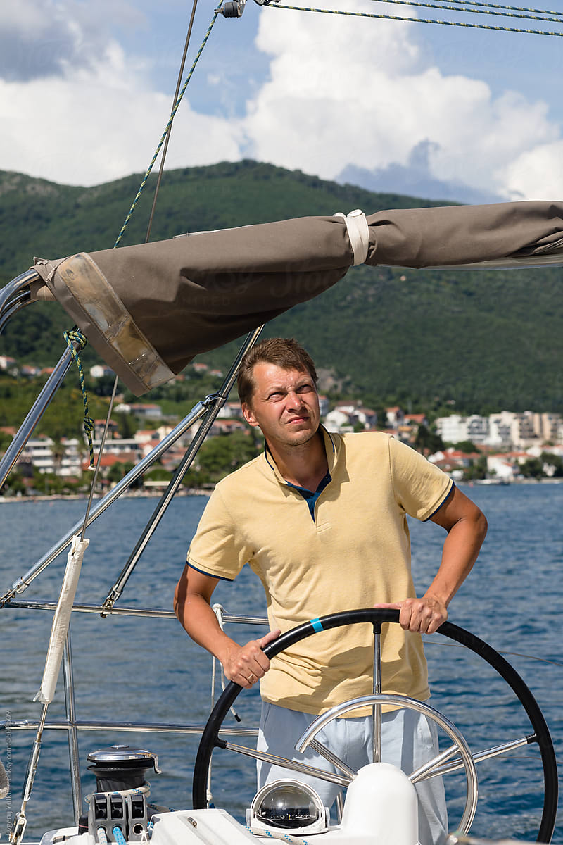 Man at the helm of a yacht
