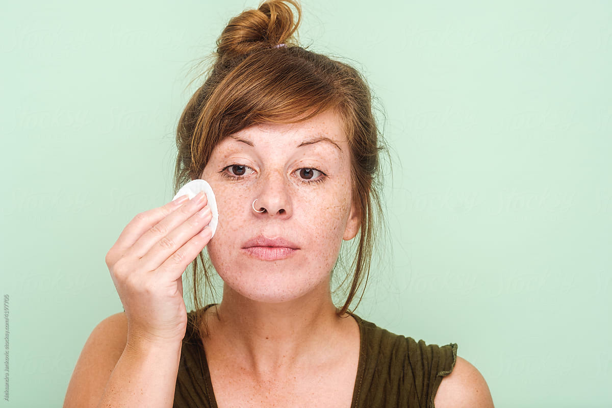 Woman With Freckles Doing Facial Cleansing