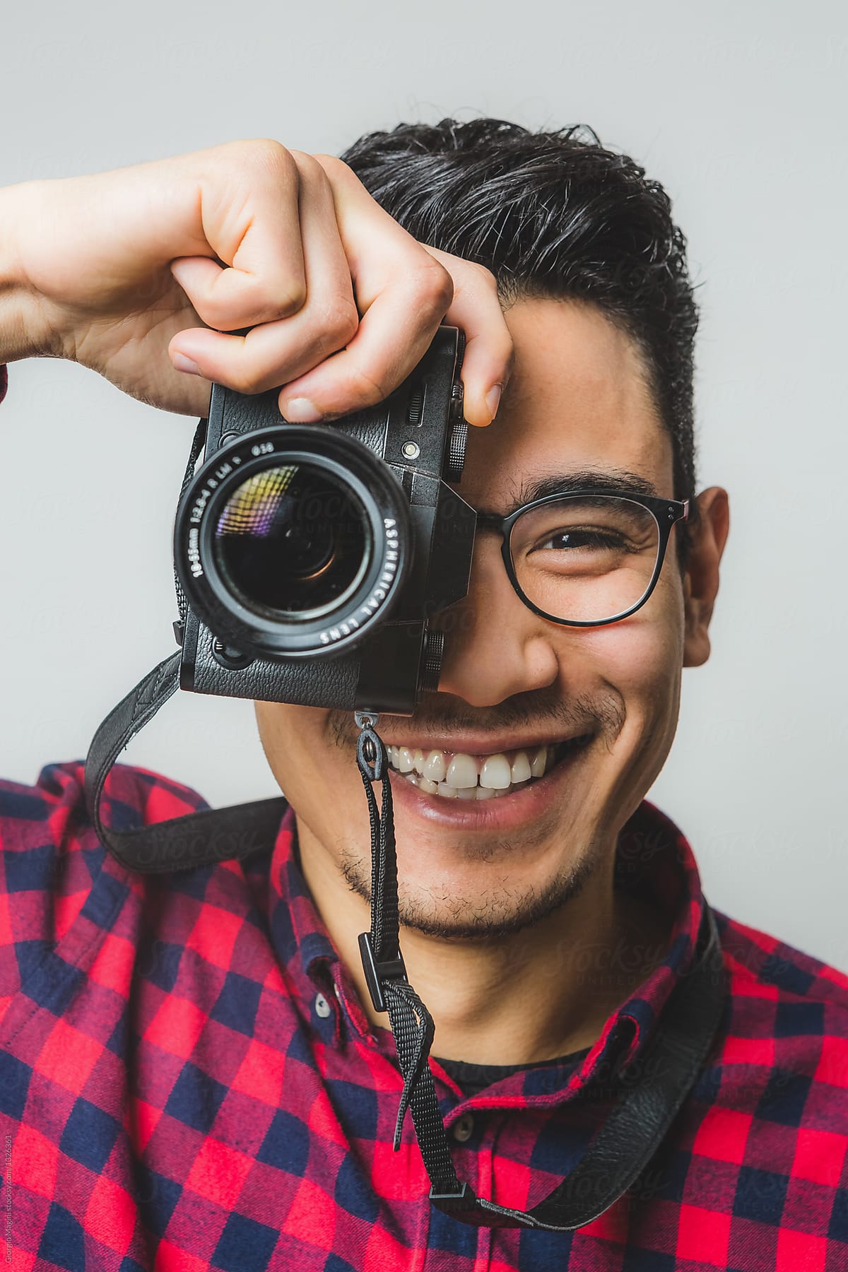 Portrait of a Smiling Creative Man with Digital Mirrorless Camer