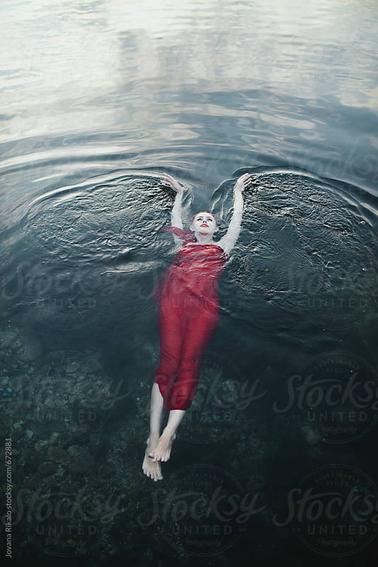Woman In A Red Dress Floating On Water By Jovana Rikalo Stocksy United 