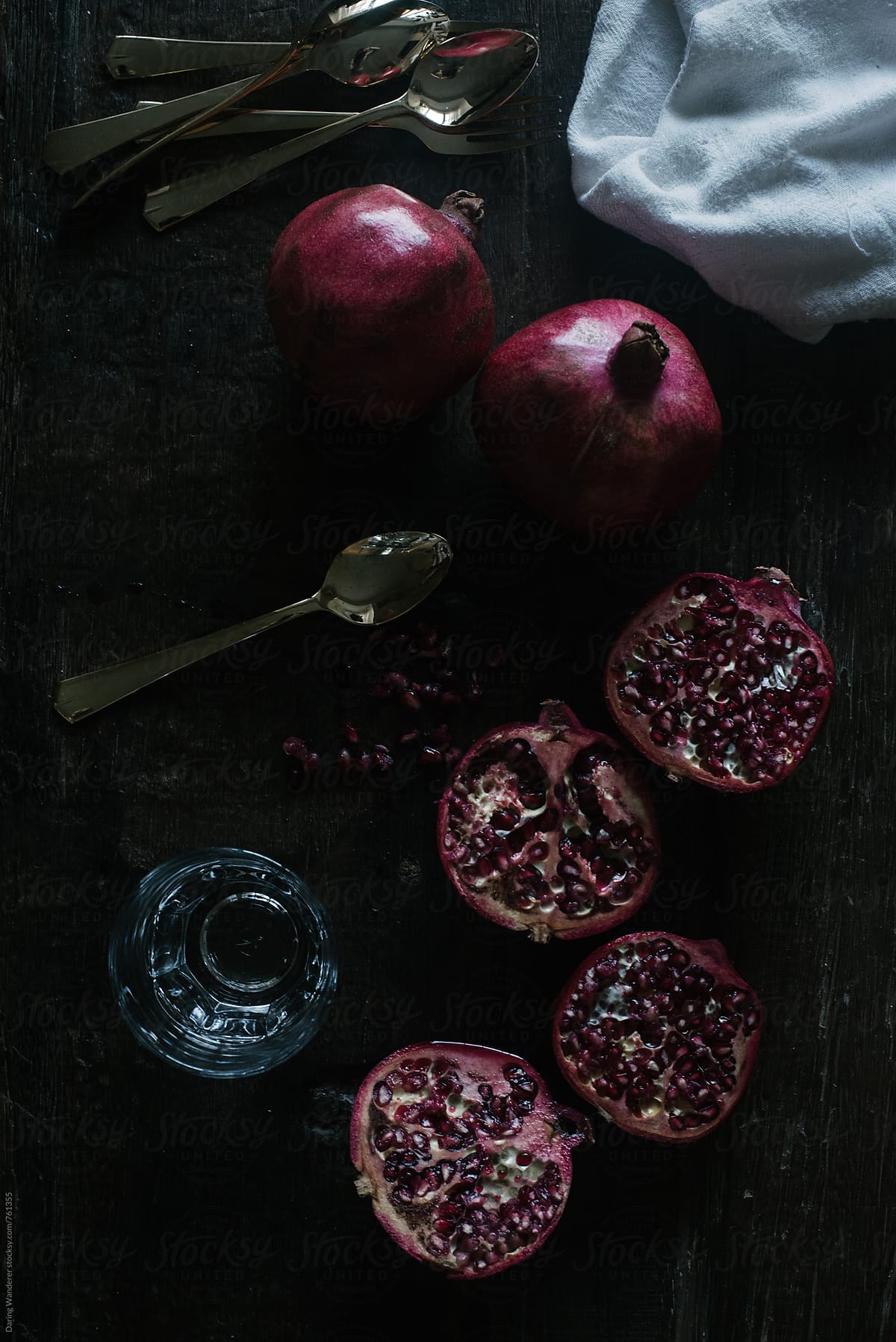 Cut pomegranate styled on dark wood table