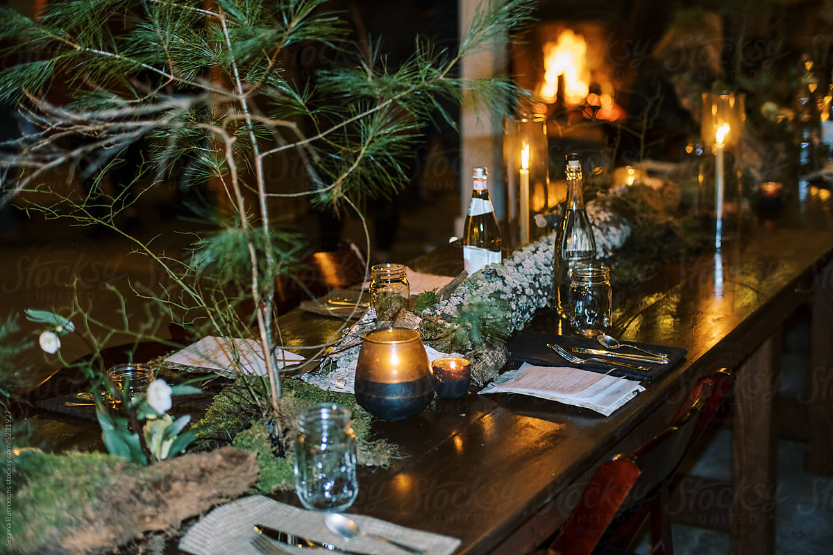 Decorated table with floral arrangements at an indoor dinner party