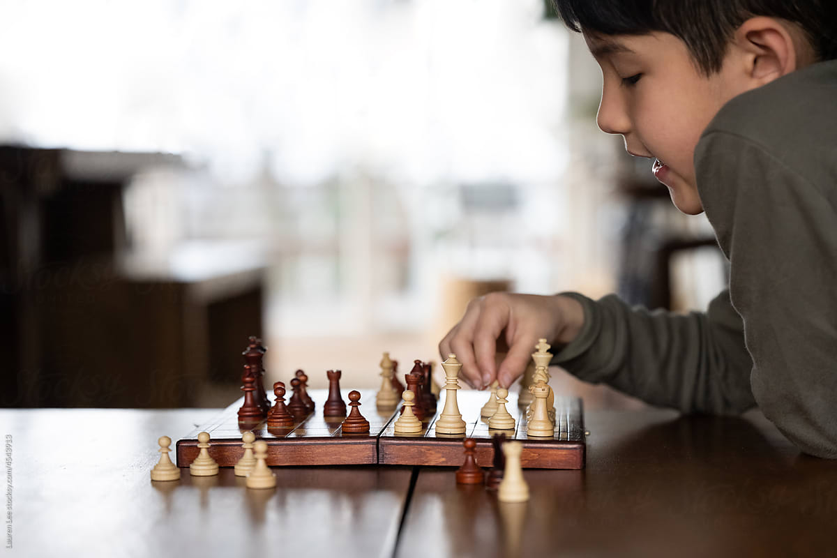 Little kid playing chess