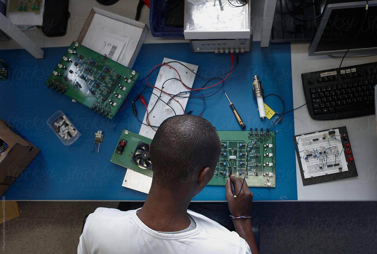 Back view from above of a black male electronic engineer at work