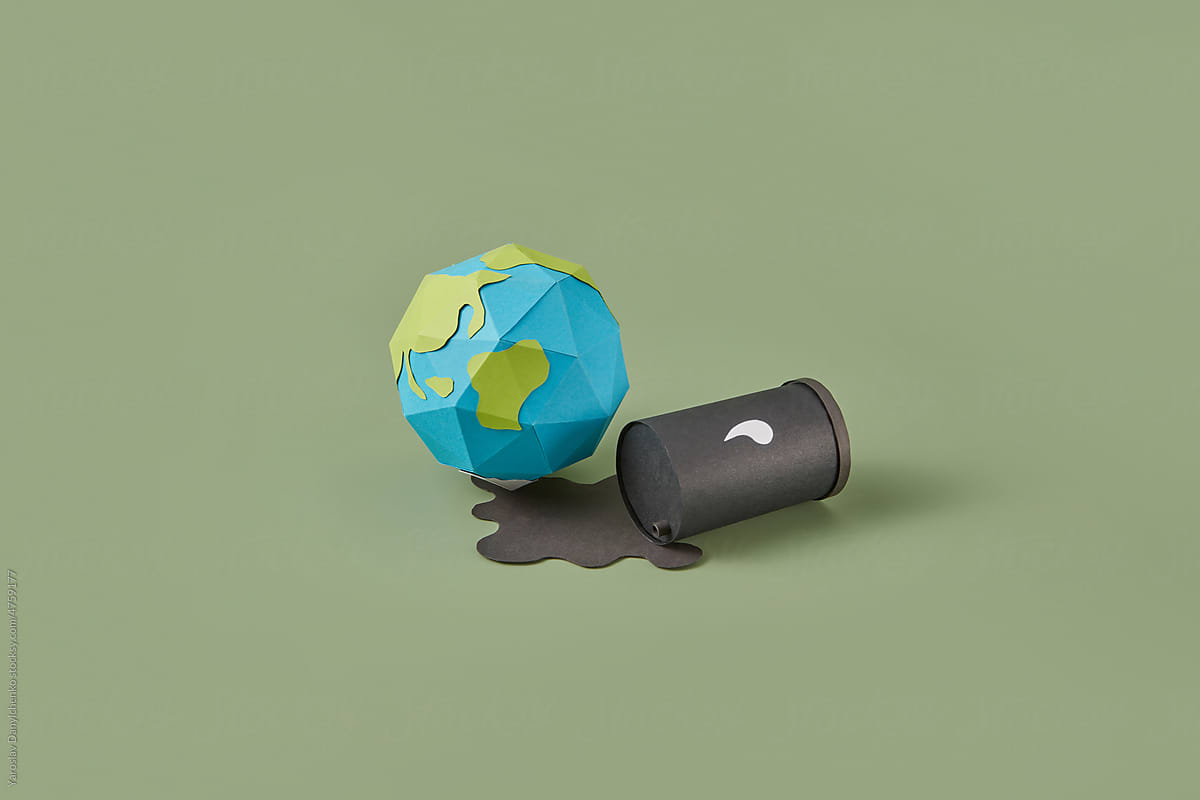 Fallen paper oil barrel and Earth planet.