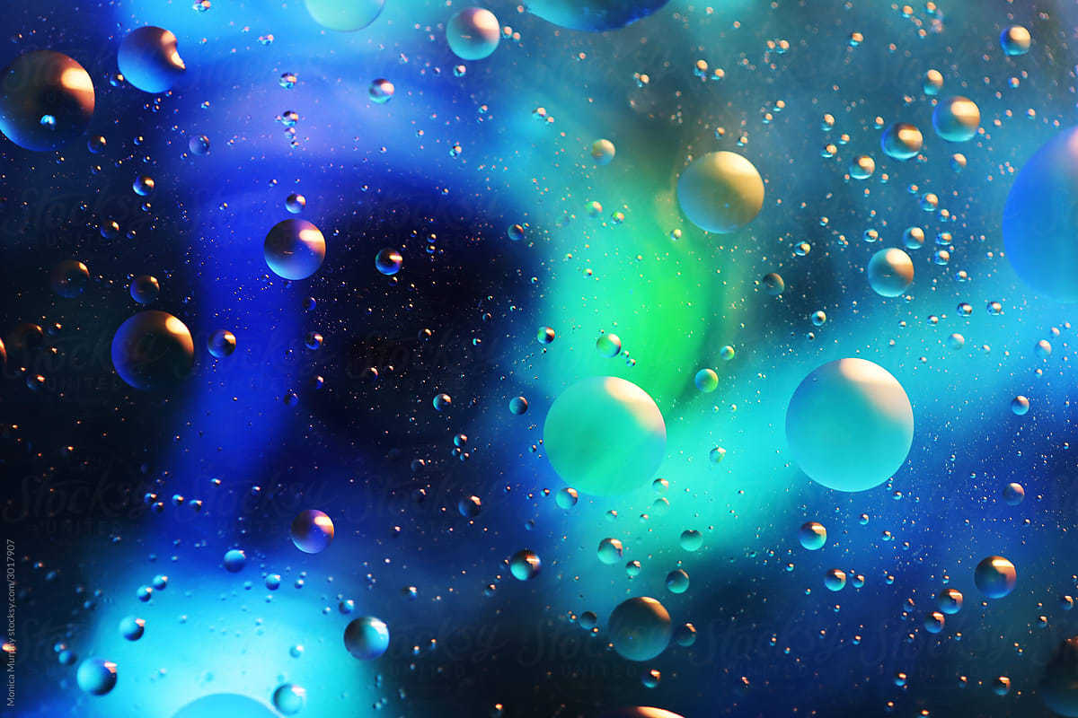 Oil bubbles floating in colored water - Macro
