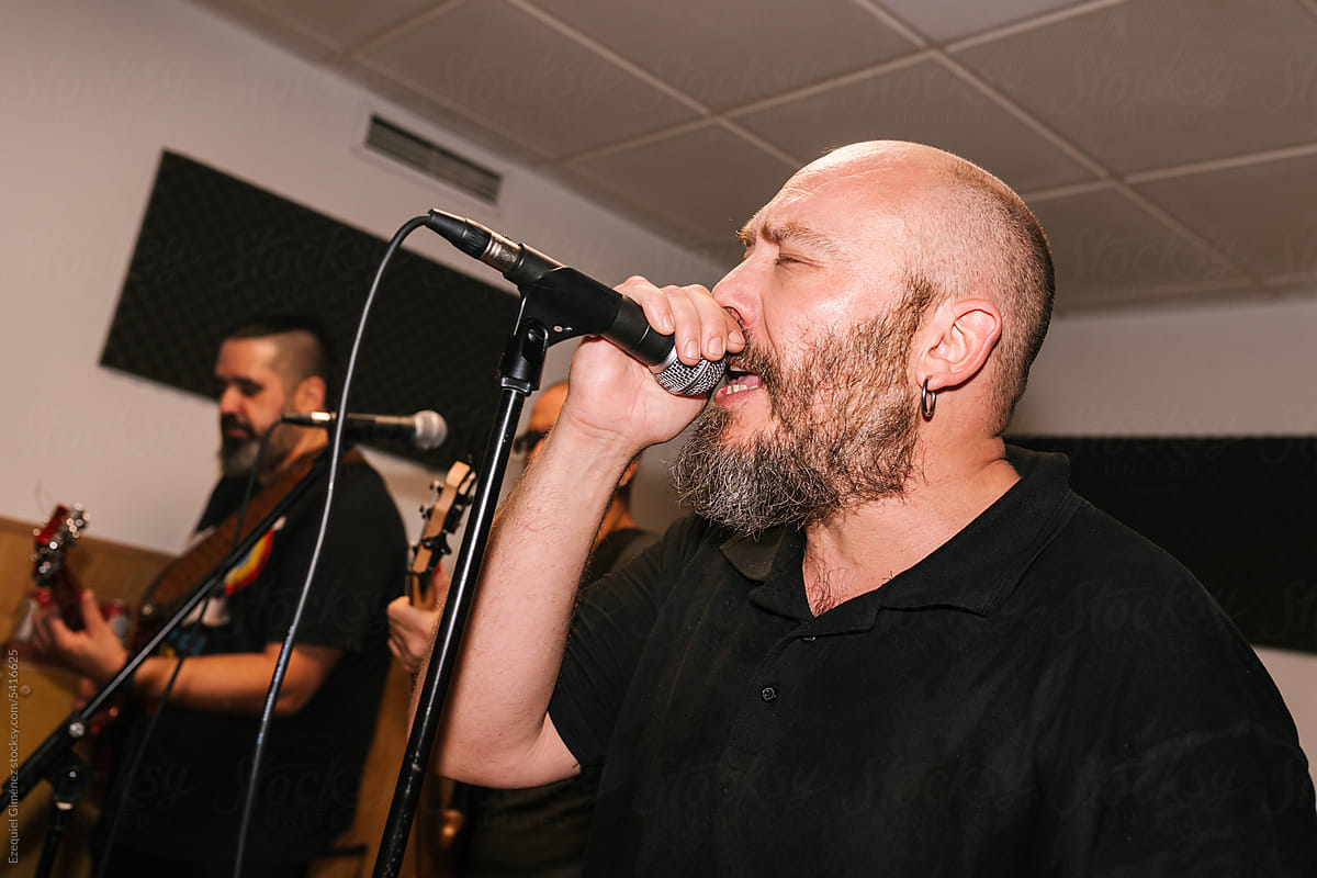 Bearded man singing into microphone