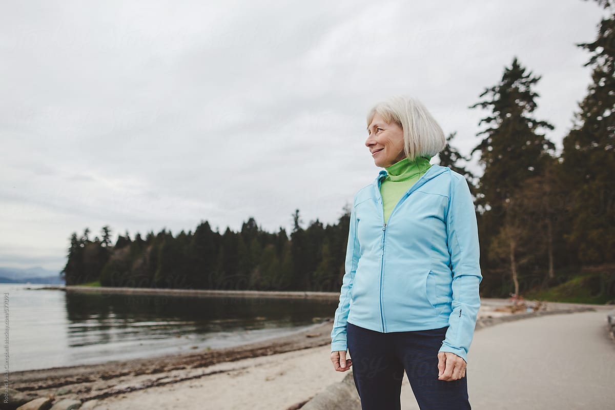 Healthy senior woman standing outside in active wear