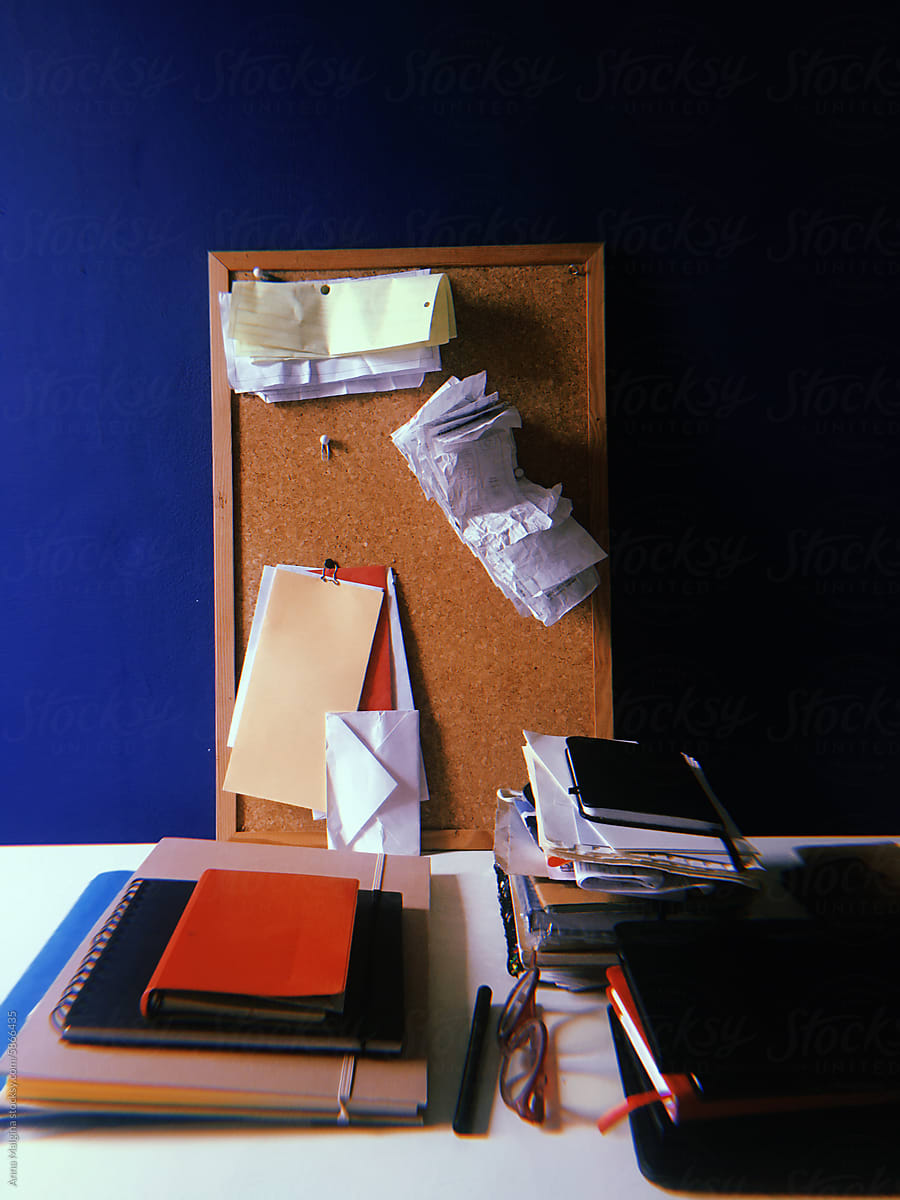 Works station with messy receipts and notebooks