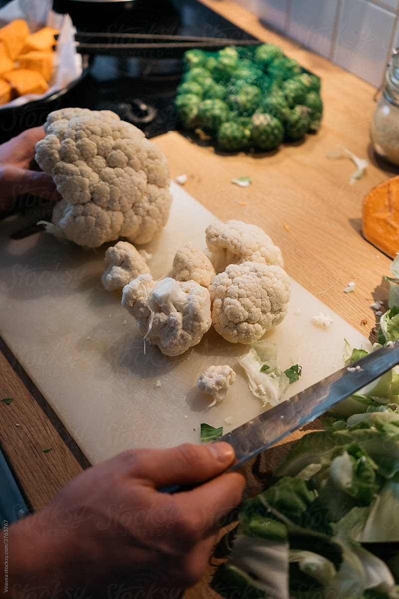 Chopped cauliflower on the cutting board next to other vegetables