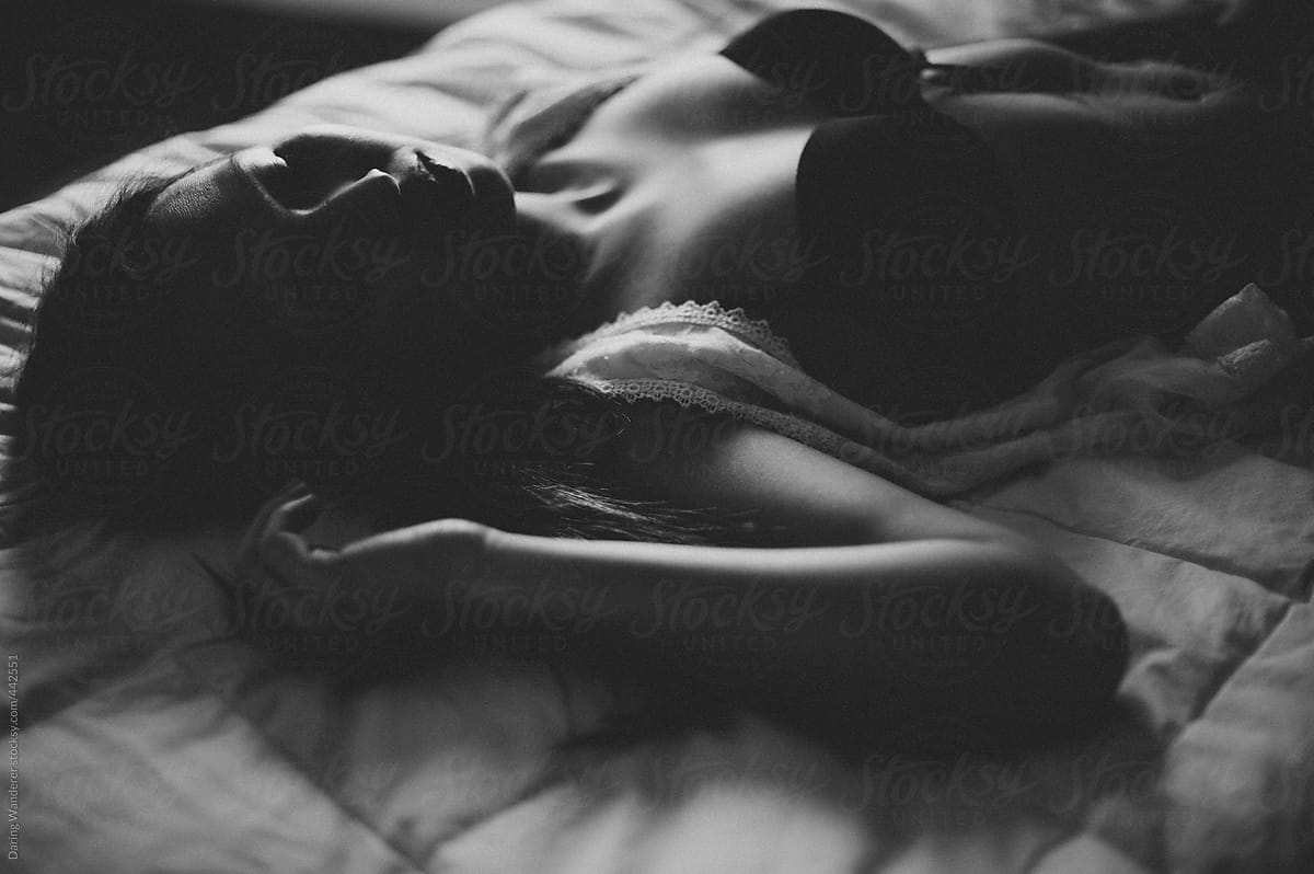 Woman In Black Lace Bra Lying On Bed by Stocksy Contributor Jess