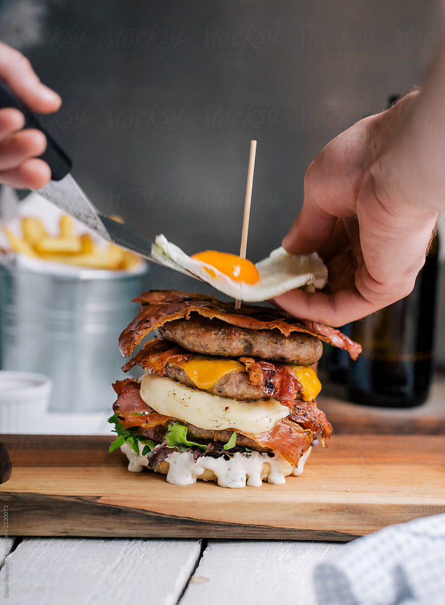 Mouth-watering burger on wooden board